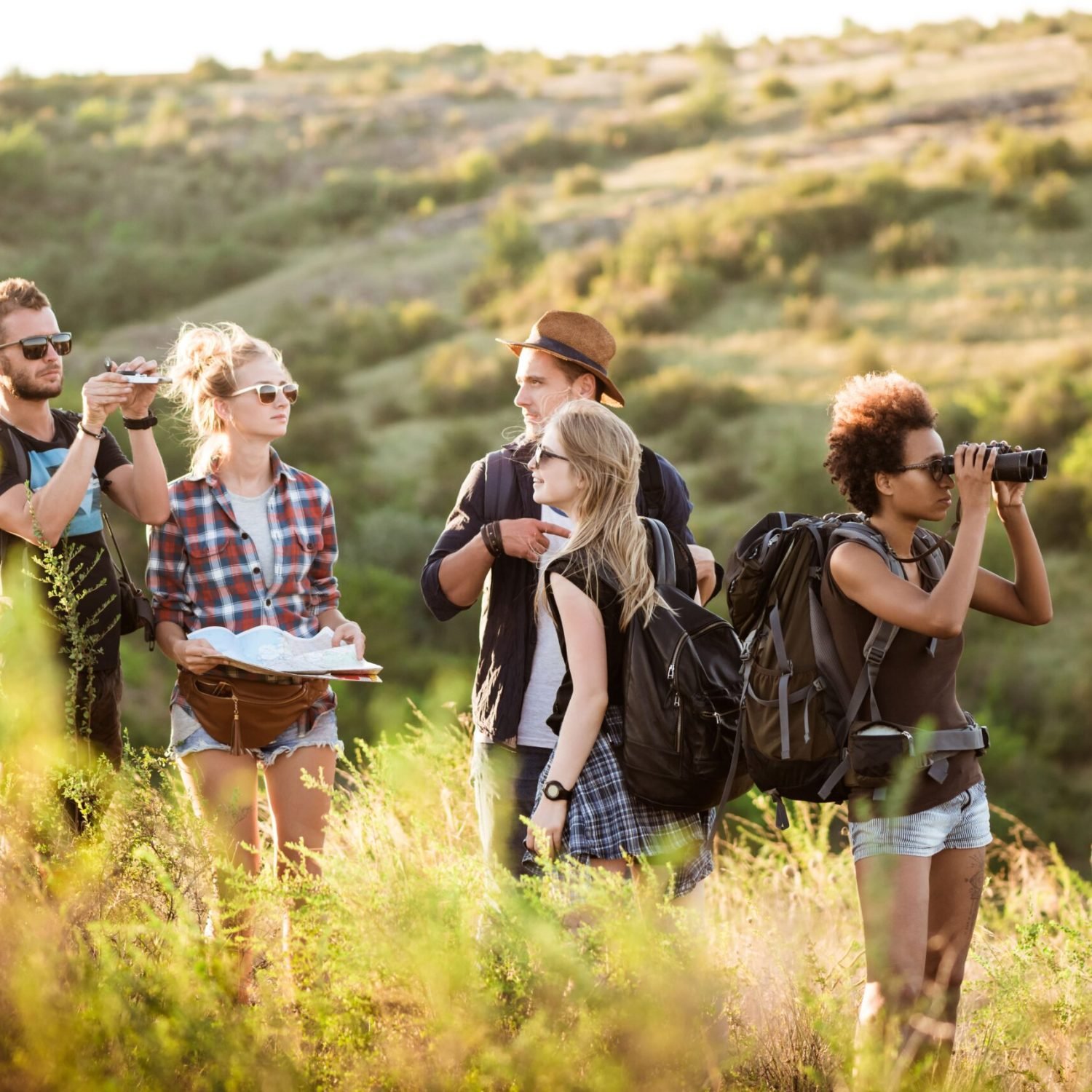 young-friends-with-backpacks-enjoying-view-traveling-canyon (1)